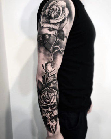 Rose sleeve tattoo for men featuring red roses and thorns in realistic detail