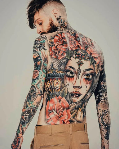 Classic rose tattoo on back for men, featuring a detailed rose with shading and petals across the shoulder blade, symbolizing love and beauty.