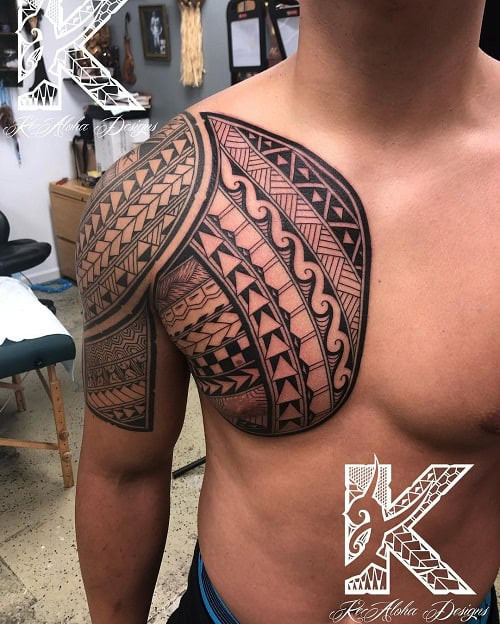 Samoan tribal tattoo on a man's arm, featuring dense, intricate patterns characteristic of Samoan tatau.