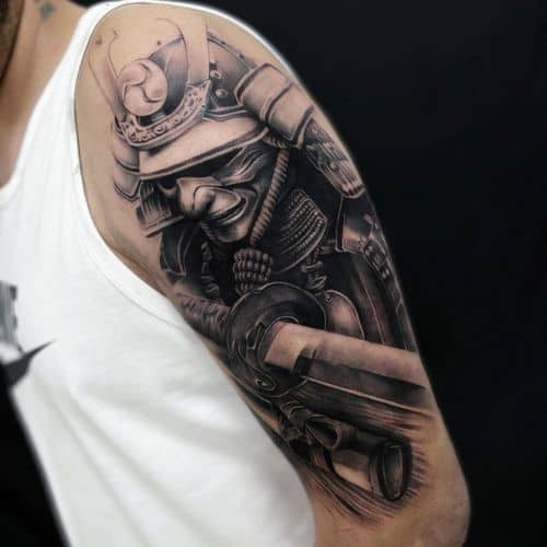 A Samurai warrior tattoo with helmet and sword on a man's arm, symbolizing honor and strength