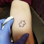 Puzzle piece autism tattoo designs in various styles and placements