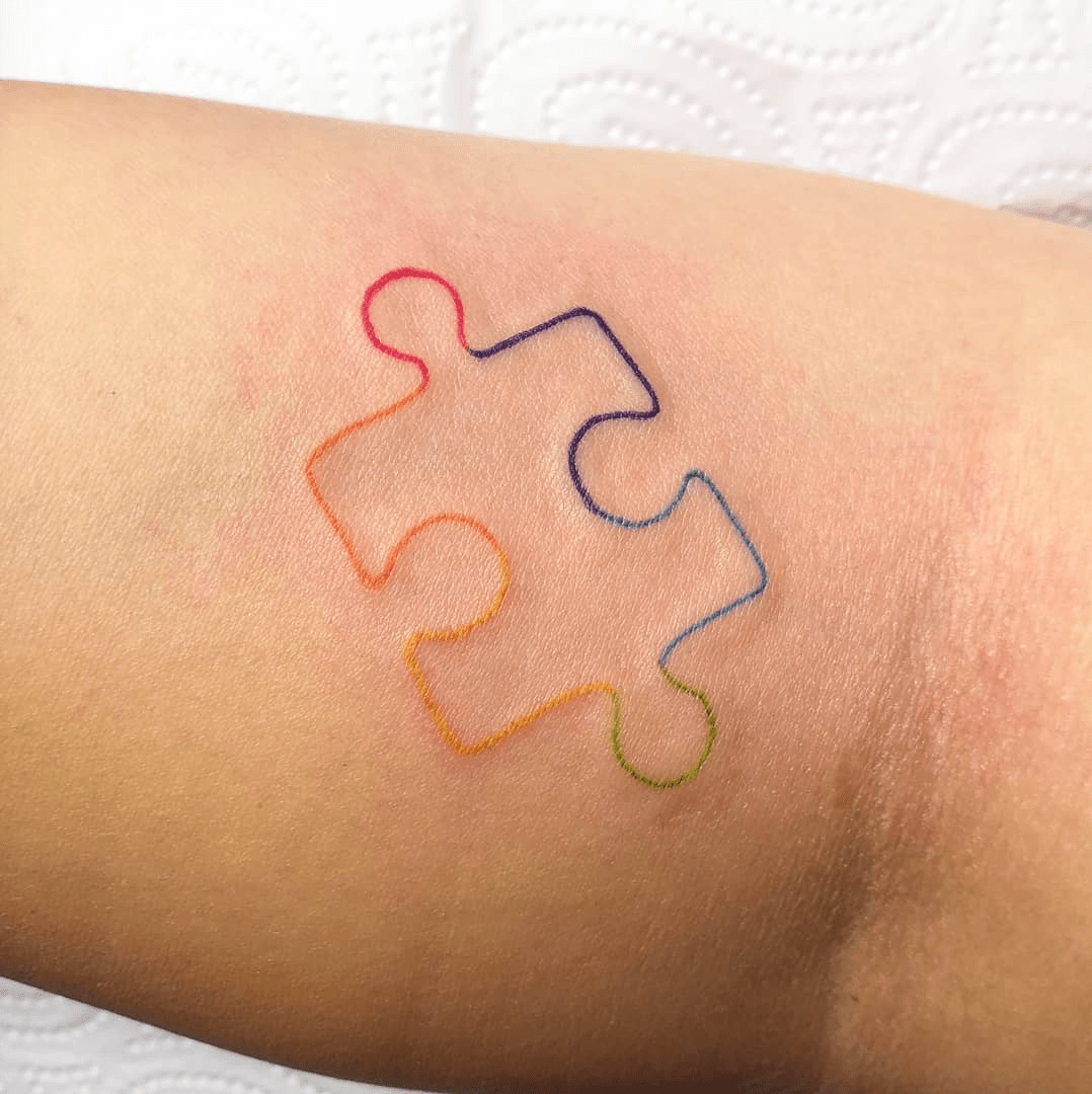 Combination autism tattoo with puzzle piece and infinity symbol interwoven, creating a richer meaning.