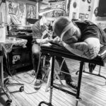 Man getting a detailed tattoo at Ghost Light Tattoo Parlor, a top-rated tattoo shop in Milwaukee, WI
