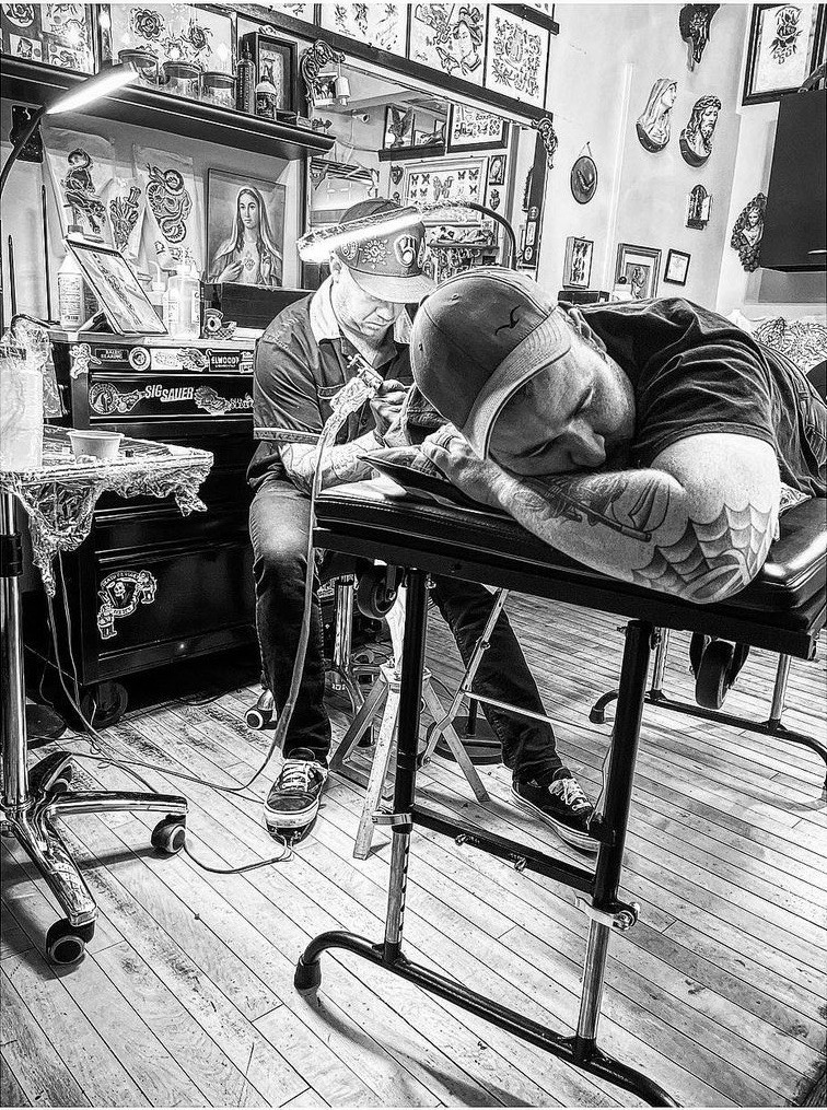 Man getting a detailed tattoo at Ghost Light Tattoo Parlor, a top-rated tattoo shop in Milwaukee, WI