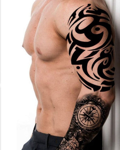 A biomechanical sleeve tattoo starting on a man's shoulder and extending down his arm