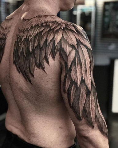An abstract geometric tattoo design on a man's shoulder blade