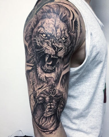 A geometric lion tattoo design on a man's shoulder