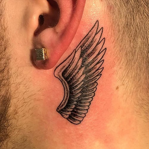 Simple angel wings outline tattoo on back, minimalist black ink for men.