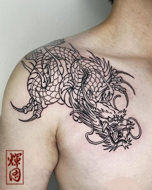 Simple dragon outline tattoo on back of arm, minimalist black ink for men.