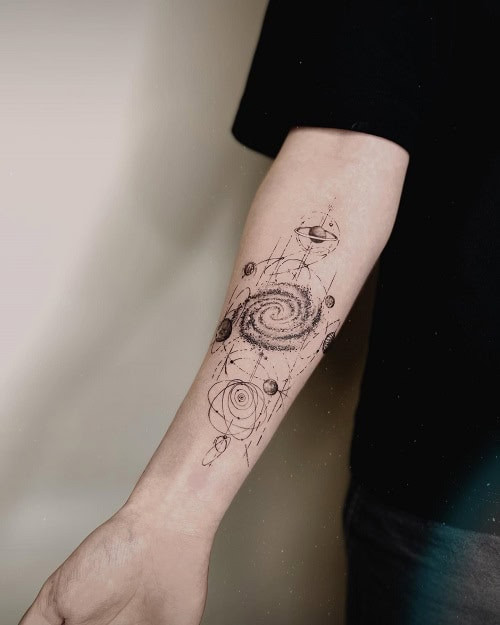 Simple galaxy swirl tattoo on forearm, minimalist black ink design for men.