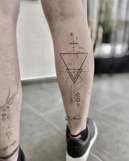 Simple geometric triangle tattoo on chest, minimalist black ink design for men.