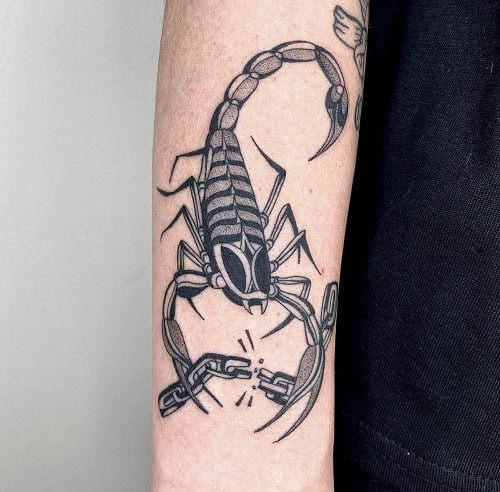 Simple scorpion silhouette tattoo on arm, minimalist black ink design for men.