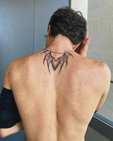 Simple back piece tattoo for men, featuring a minimalist design across the back