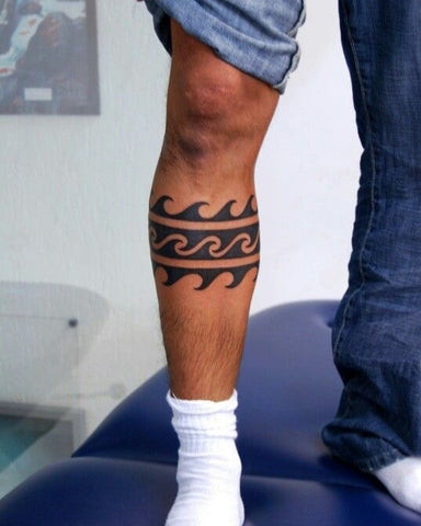 Understated simple leg tattoo for men featuring delicate line work