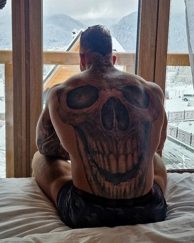 Skull tattoo back art, intricately designed to symbolize strength and mortality