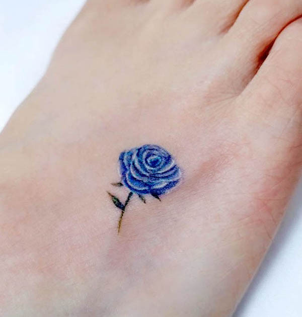 Small blue rose foot tattoo, symbolizing rarity, standing out from the norm, and a unique personality