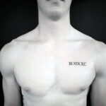 Man with a small chest tattoo