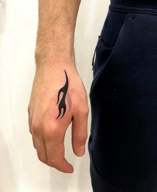 Small flame outline tattoo on a man's chest