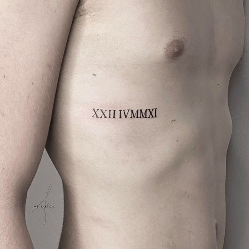 Discreet Small Roman Numeral Tattoo on a man's wrist