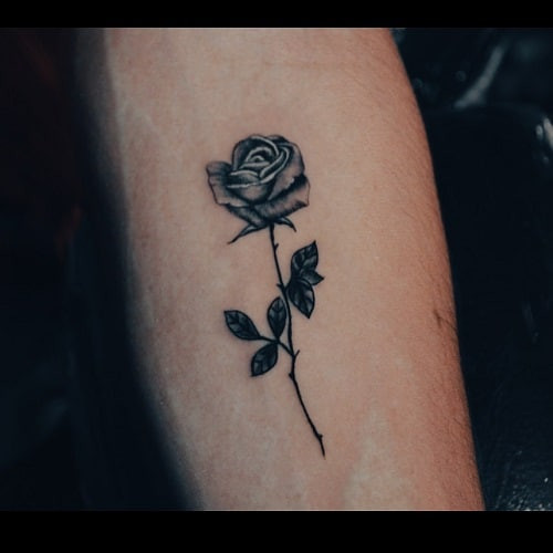 Subtle small rose tattoo on wrist