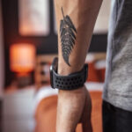 Small arm tattoo of a geometric design, a popular choice for men's subtle ink.