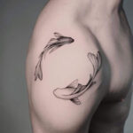 A minimalist geometric triangle tattoo on a man's collarbone area