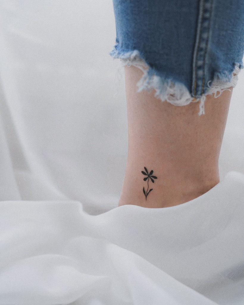 A minimalist outline of a coffee cup on a woman's wrist, representing simple pleasures and daily rituals.