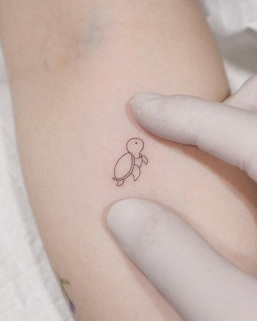 A tiny, elegant moon phase tattoo behind a woman's ear, symbolizing cycles and femininity.