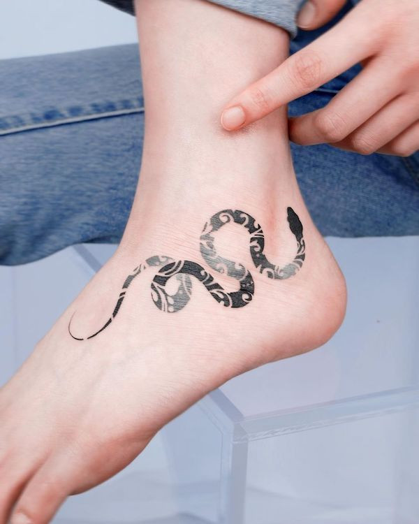 Snake foot tattoo, a popular and versatile design adding mystery and badassness to the foot