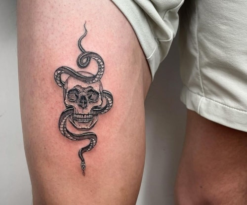 Geometric snake tattoo on a man's forearm