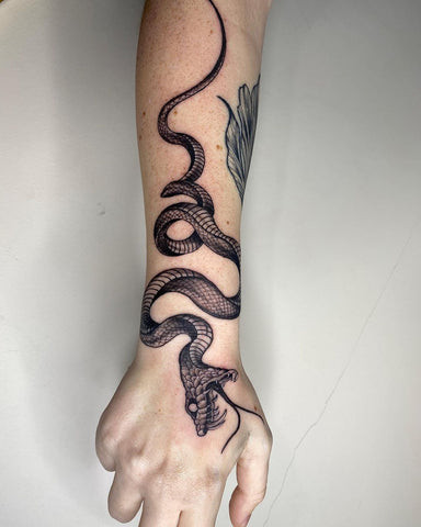 Snake forearm tattoo drawing with winding scales and captivating eyes.