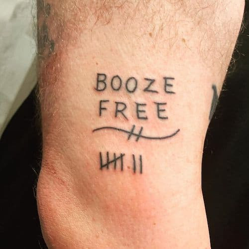 Sobriety date tattoo on a man's arm