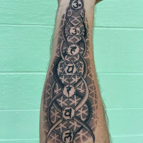 Two soul tattoos on men, one on the forearm with a spiritual symbol and another on the arm with a minimalist soul tattoo design.