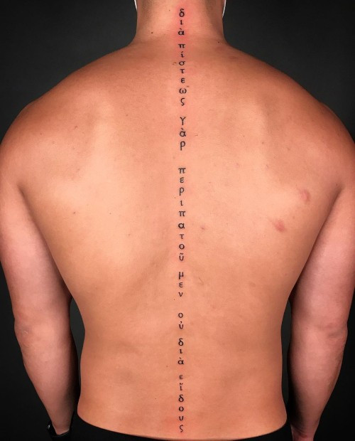 Spine tattoo with a geometric design, a vertical and striking placement for men.