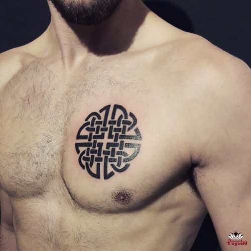 A spiritual Yin and Yang tattoo with flowing lines on a man's chest, symbolizing balance