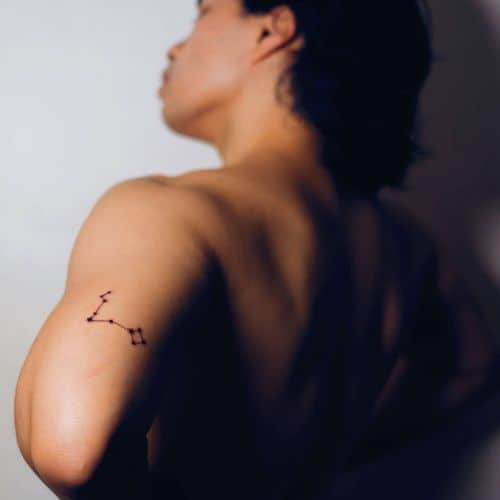 Constellation tattoo depicting zodiac signs on a man's shoulder