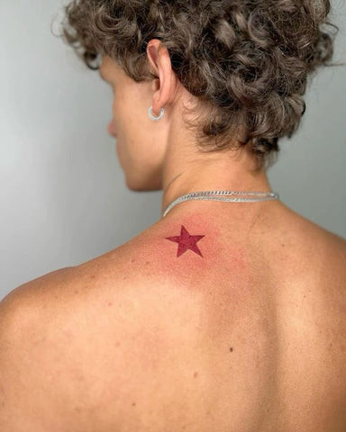 A star back tattoo with a constellation design, symbolizing ambition and dreams.