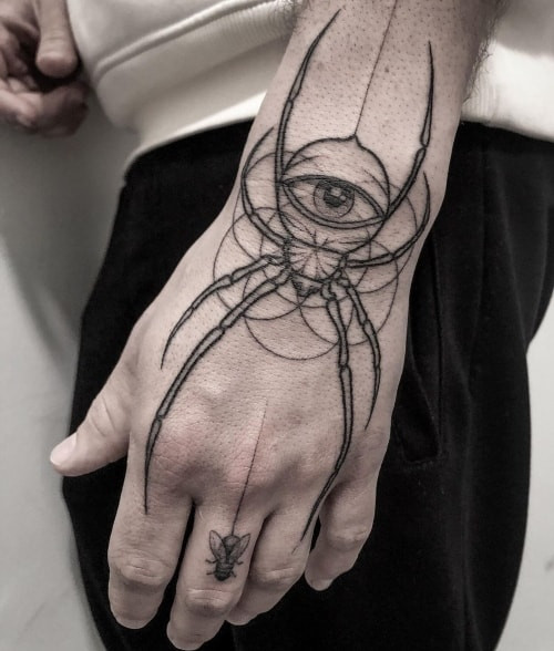 Geometric stick and poke tattoo on a man's arm