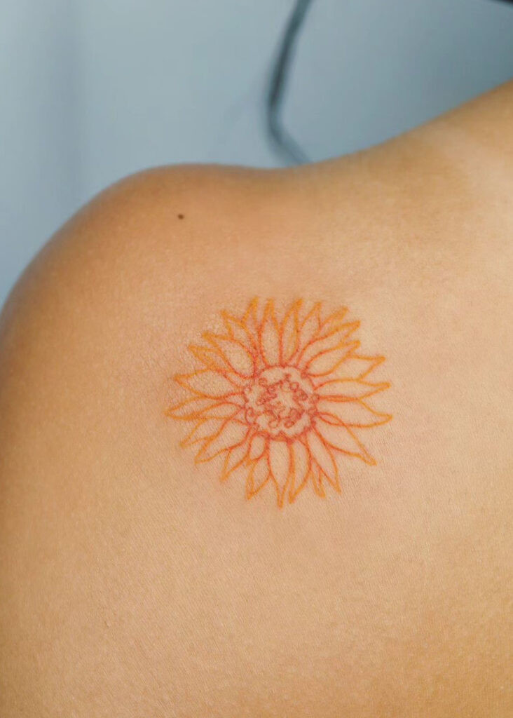 Orange ink sunflower shoulder tattoo