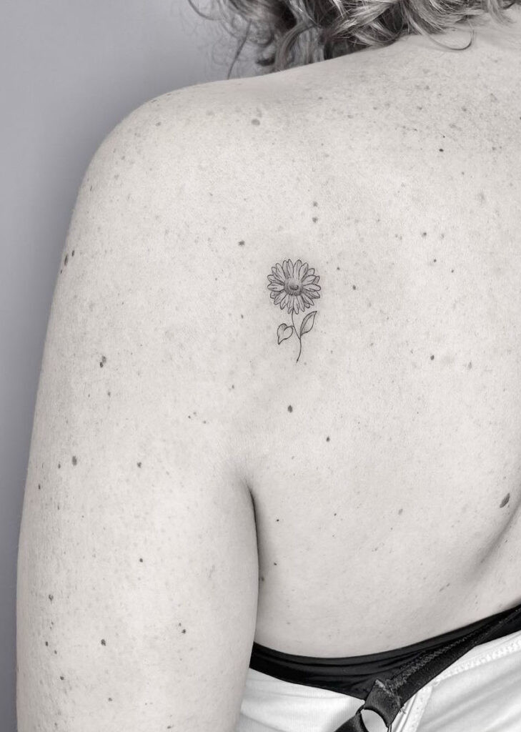 Tiny shoulder blade sunflower illustration tattoo