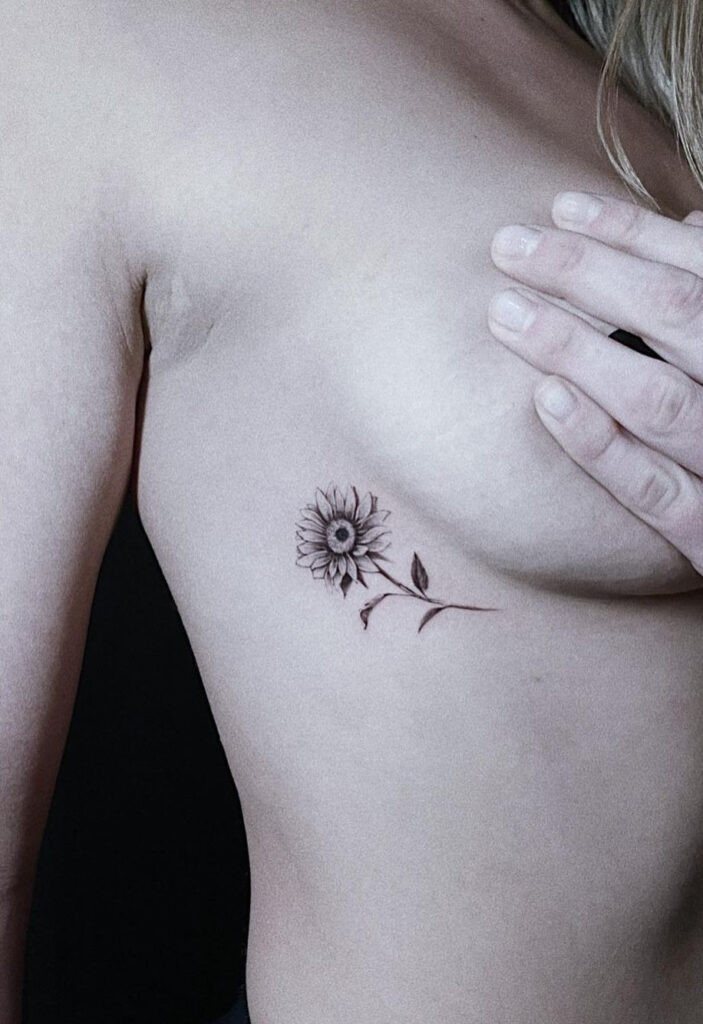 Black and white hidden sunflower ribcage tattoo