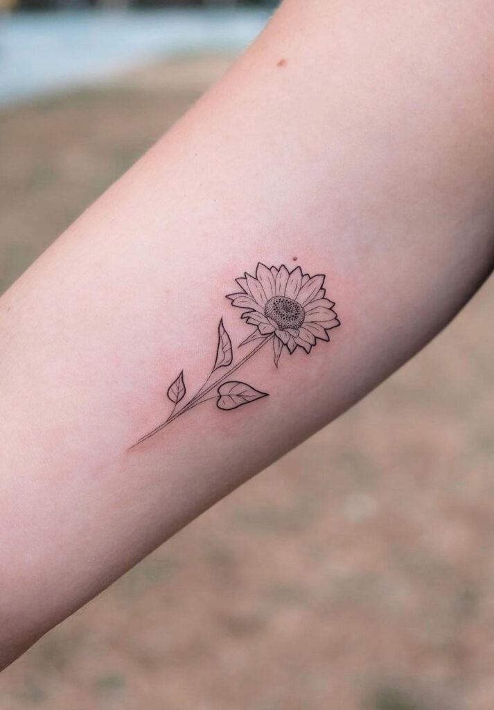 Small detailed sunflower line art arm tattoo