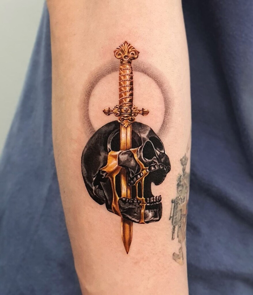 Skull and sword tattoo design representing mortality, strength, and courage. This tattoo design can be a powerful message of resilience and inner strength.