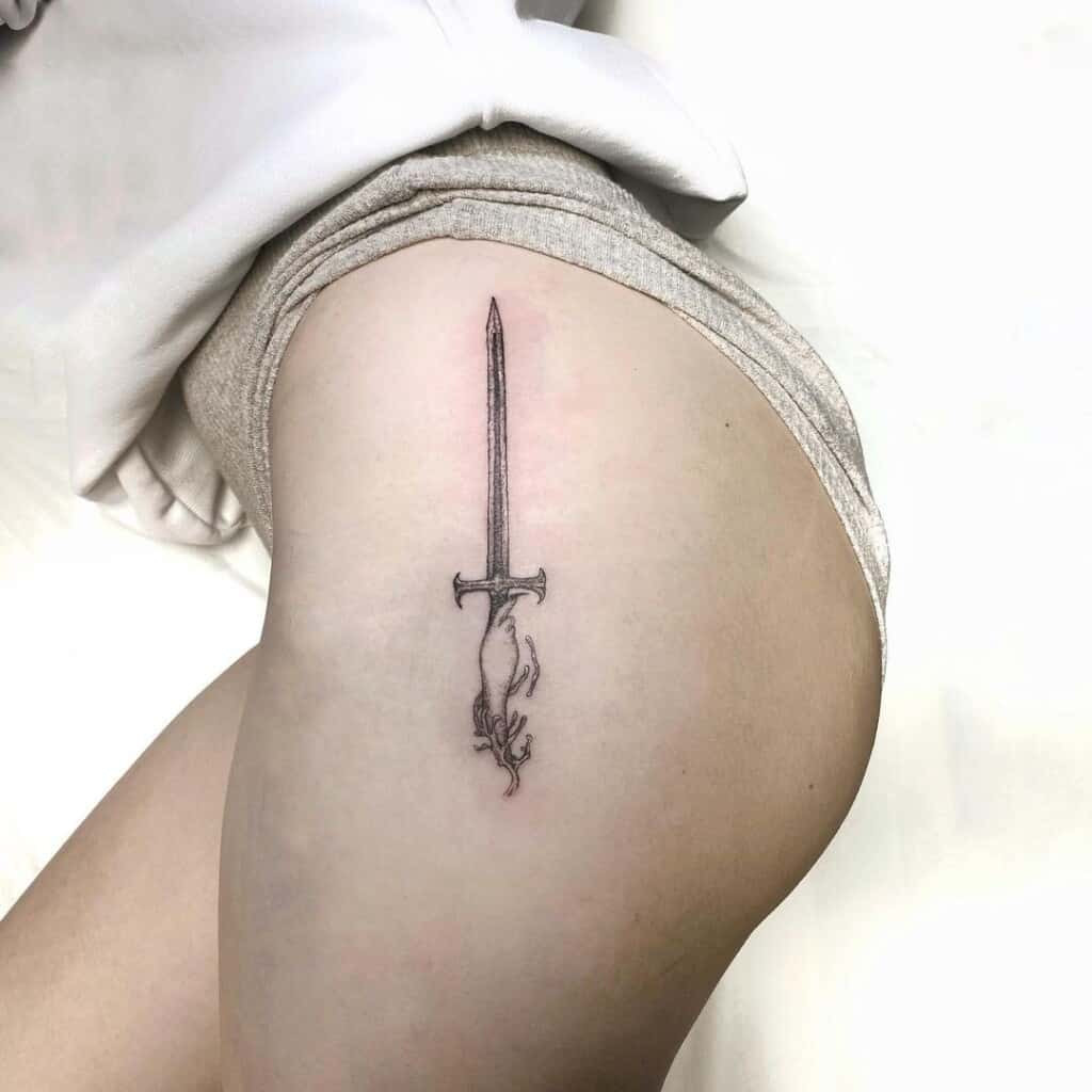 Tribal sword tattoo design, incorporating bold lines and geometric patterns for a strong and culturally inspired look.