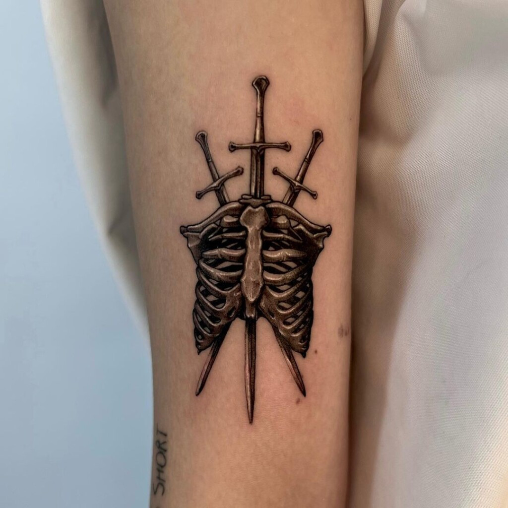 Ornamental sword tattoo design with detailed embellishments and decorative elements, highlighting the artistry and craftsmanship of sword making.