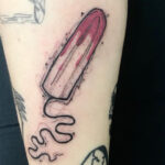 Tattoo of a tampon with floral designs, symbolizing menstruation and body art