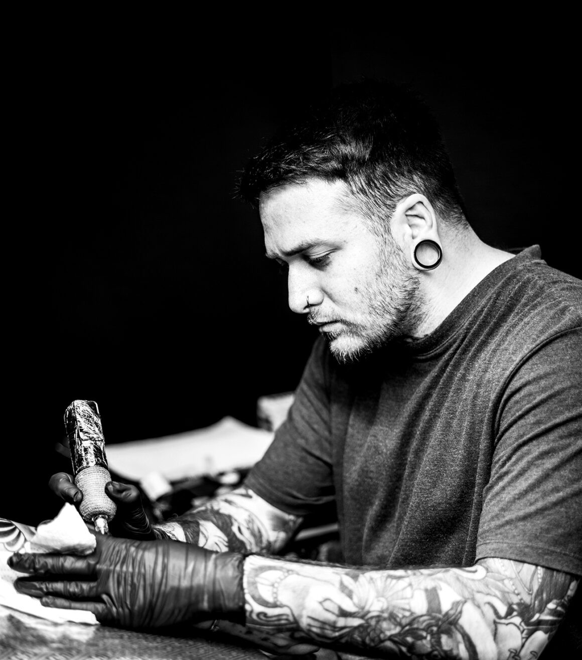 Portrait of tattoo artist Tony Faith, known for his exceptional female face tattoos.