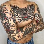 Tattoo by Ducky, showcasing bold traditional style and intricate linework