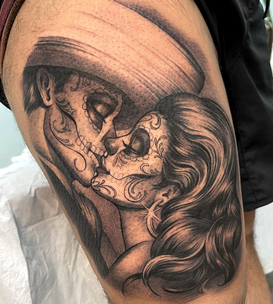 Black and grey Mexican style tattoo featuring intricate linework and shading, by Elvia Guadian