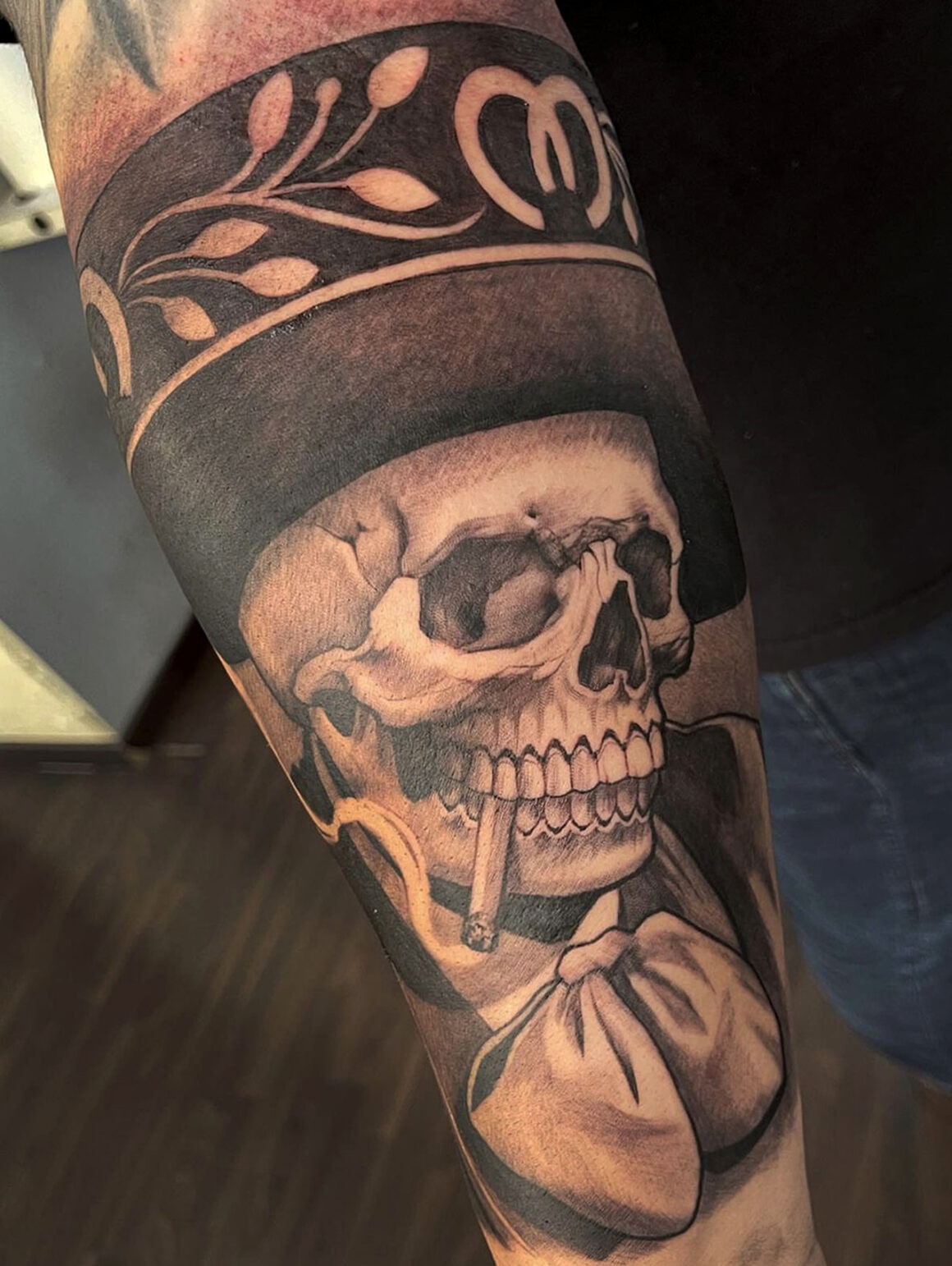 Tattoo by Elvia Guadian featuring intricate black and grey linework, showcasing Mexican-inspired artistry